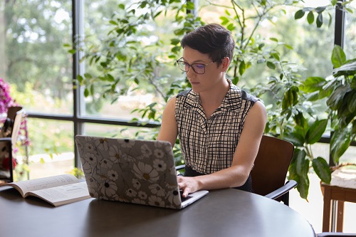 Woman studying at computer on table Woman studying at computer on table