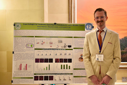  Shane Holmes presents his poster at the Research at the Capitol event.