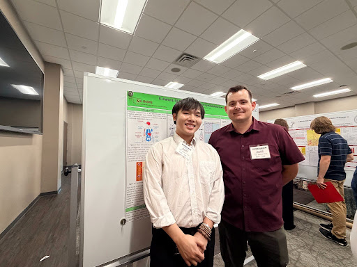 Thien Dang and Garrett Largent at the poster presentation session of the annual OK-INBRE conference.