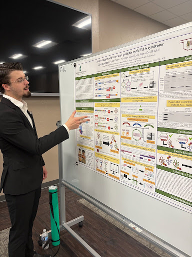 Tyler Armstrong presenting his research poster at the OK-INBRE SURP Symposium.