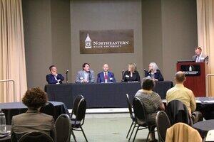 Panelists at table on BA campus Panelists at table on BA campus