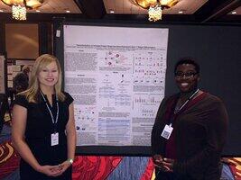 Dr. Kemp and Jocelyn Couch beside presentation poster