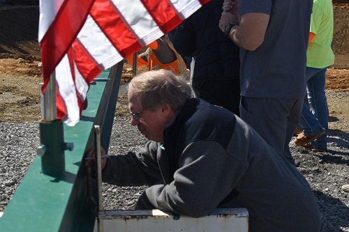 Dr. Alan McKee signing the beam. 