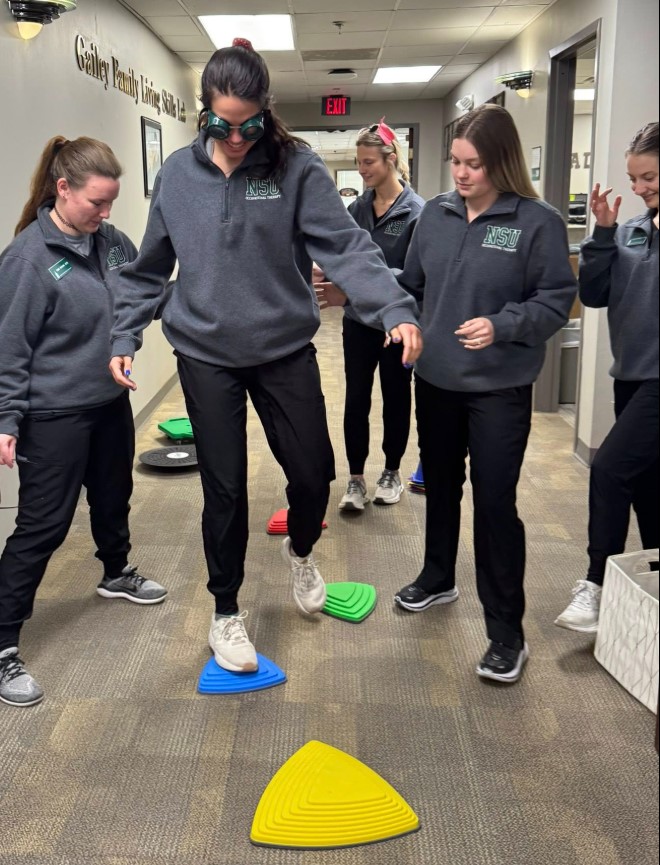 OT students practicing low vision assessments with Alumni Tara Ottenbacher OT students practicing low vision assessments with Alumni Tara Ottenbacher