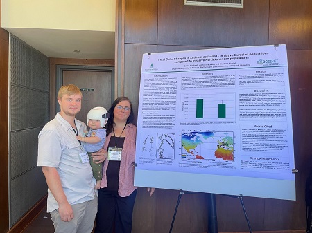 Ashton Blackwell and Zackori Blackwell (and honorary lab member Solaris) with their poster at the conference.