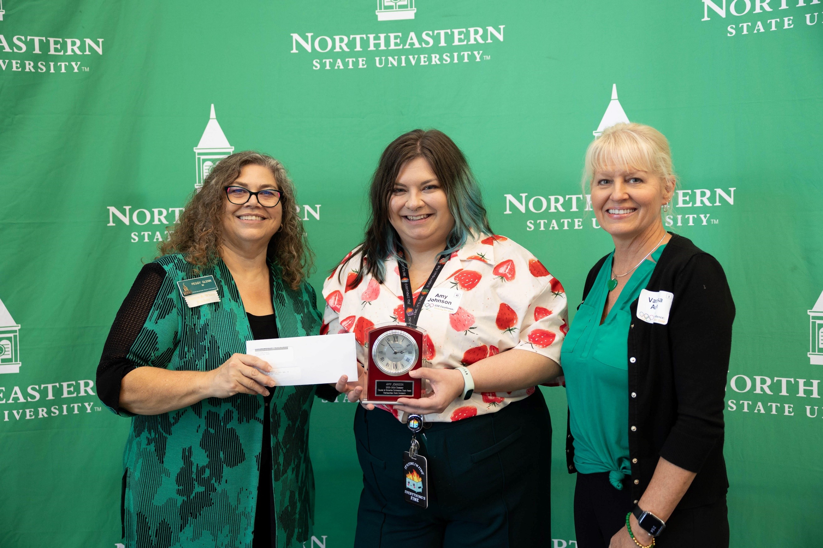 Ms. Amy Johnson (center) receiving award