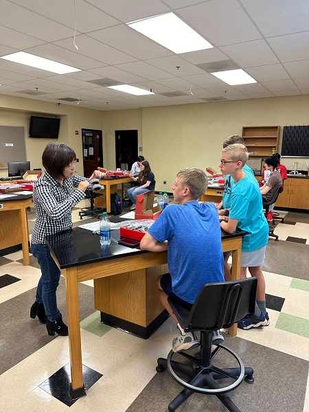 Dr. Weihuan Zhao with participants from the Robotics for Young Scientists and Engineers Summer Academy.