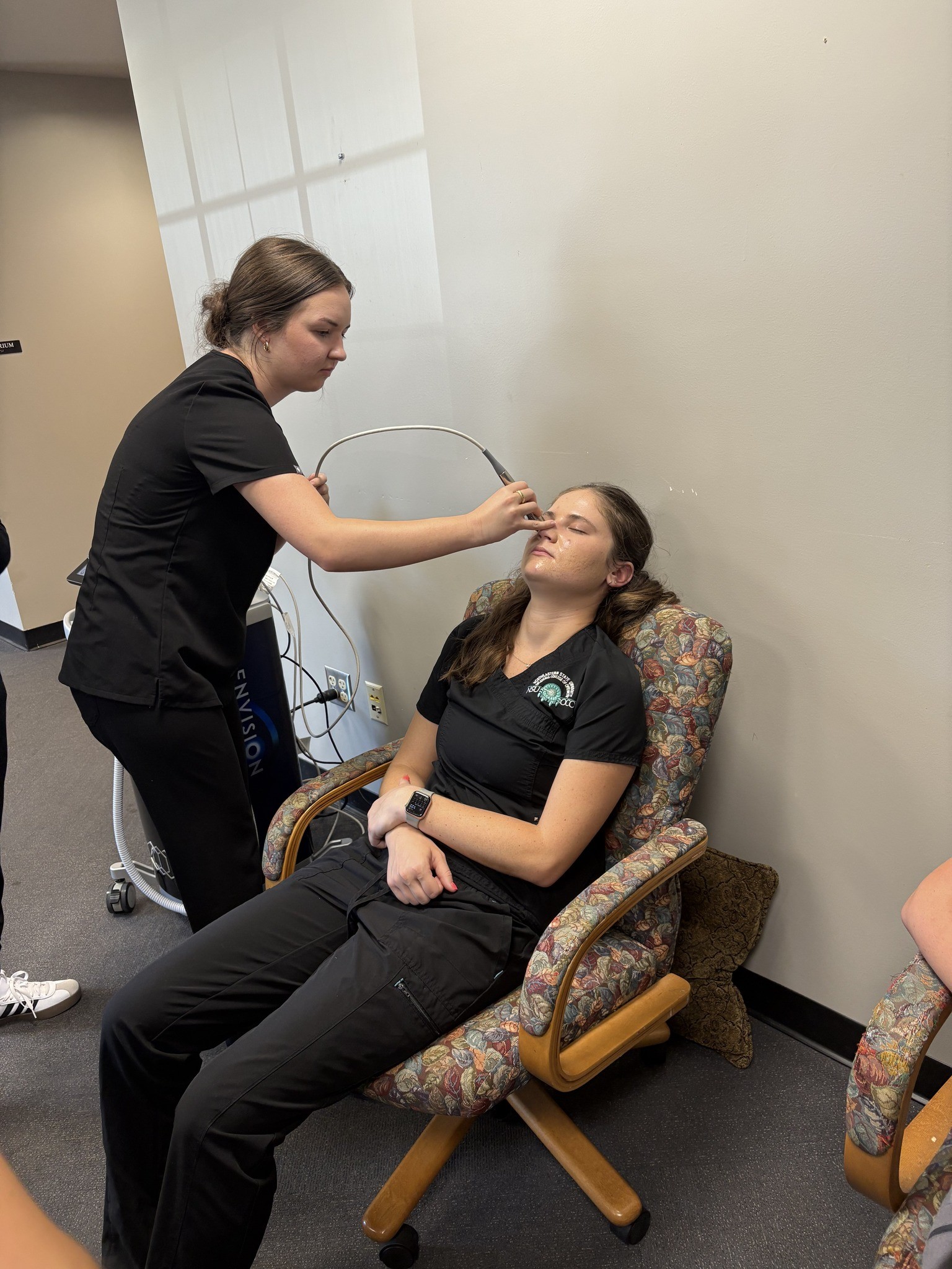 Optometry student, Rachel Psomas, performs radio frequency therapy on classmate, Haelynn Depriest.