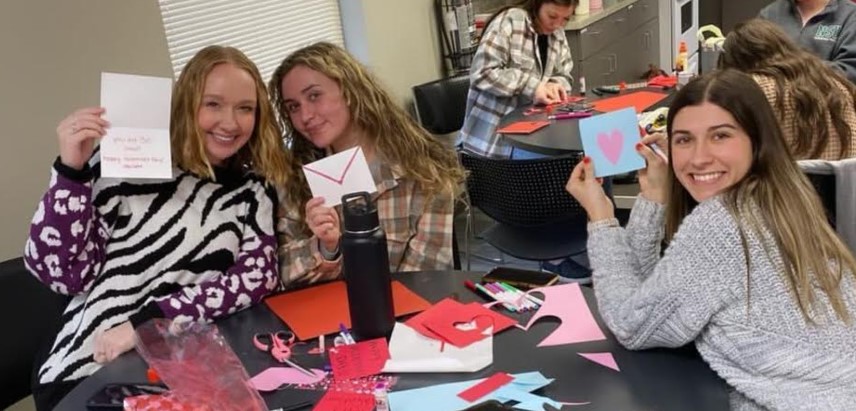 Students holding Valentine’s Day cards for the Muskogee Nursing Center.