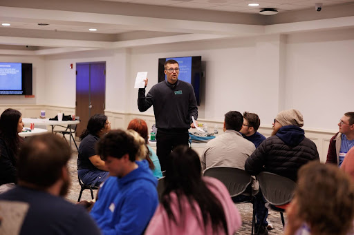 Dr. Kyle Vareberg leads workshop attendees in a "Small Talk Scavenger Hunt" designed to prompt potential small talk with others