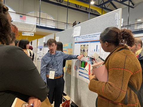 Jonathan Crosse presenting his poster to an audience during Oklahoma Research Day.