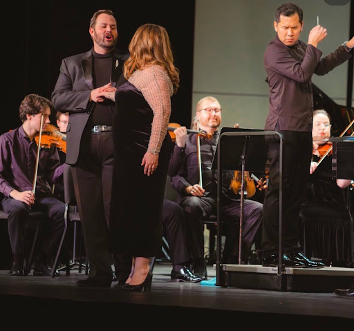 Justin Kroll and Alexandra Schoeny performing "O soave fanciulla" with conductor Wilber Lin (right) leading the Missouri Symphony.