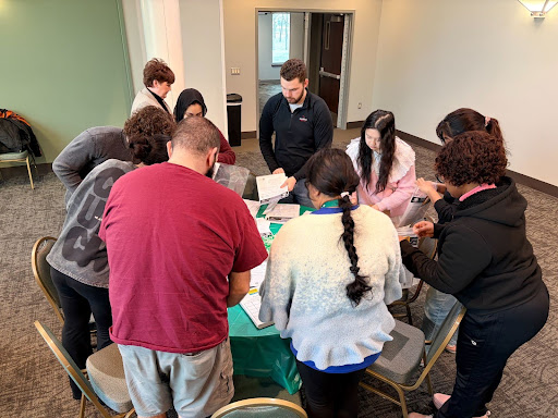 Faculty, staff, and students preparing kits at the Meet, Mingle, and Make an Impact event