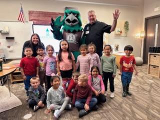 NSU mascot, Rowdy, with retired Chief of Police visitng class in Broken Arrow as part of the Read Across America Program.  