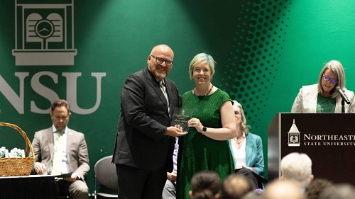 Lydia Ostmo, Outstanding Graduate Student receives the award from Dr. Hanley 