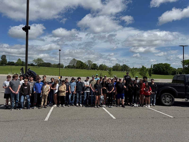 Group of students posing in front of the NSU fishing bass boat