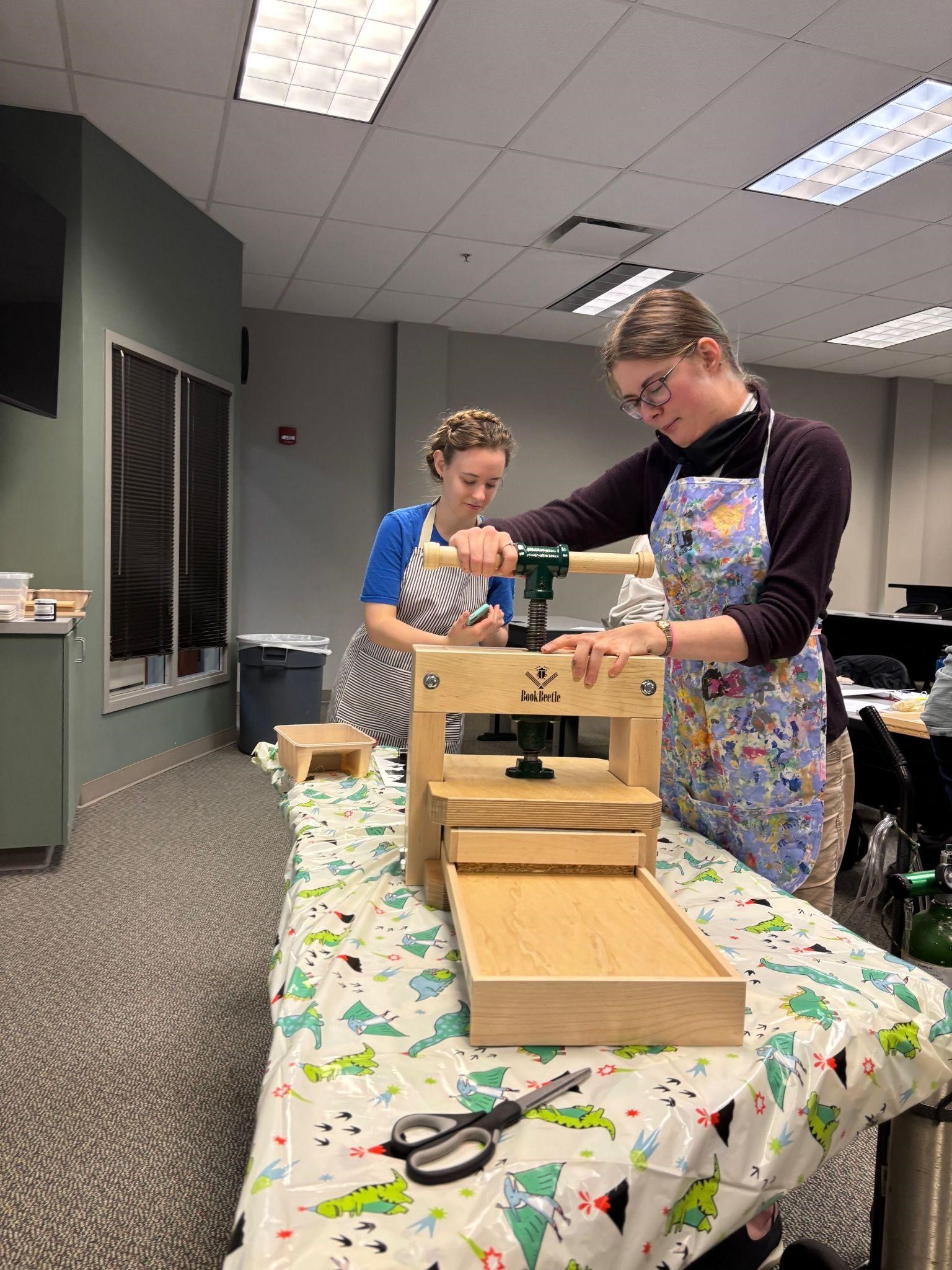 Sarah Ray and Lydia Spicer use the BookBeetle press to imprint their page. Sarah Ray and Lydia Spicer use the BookBeetle press to imprint their page.
