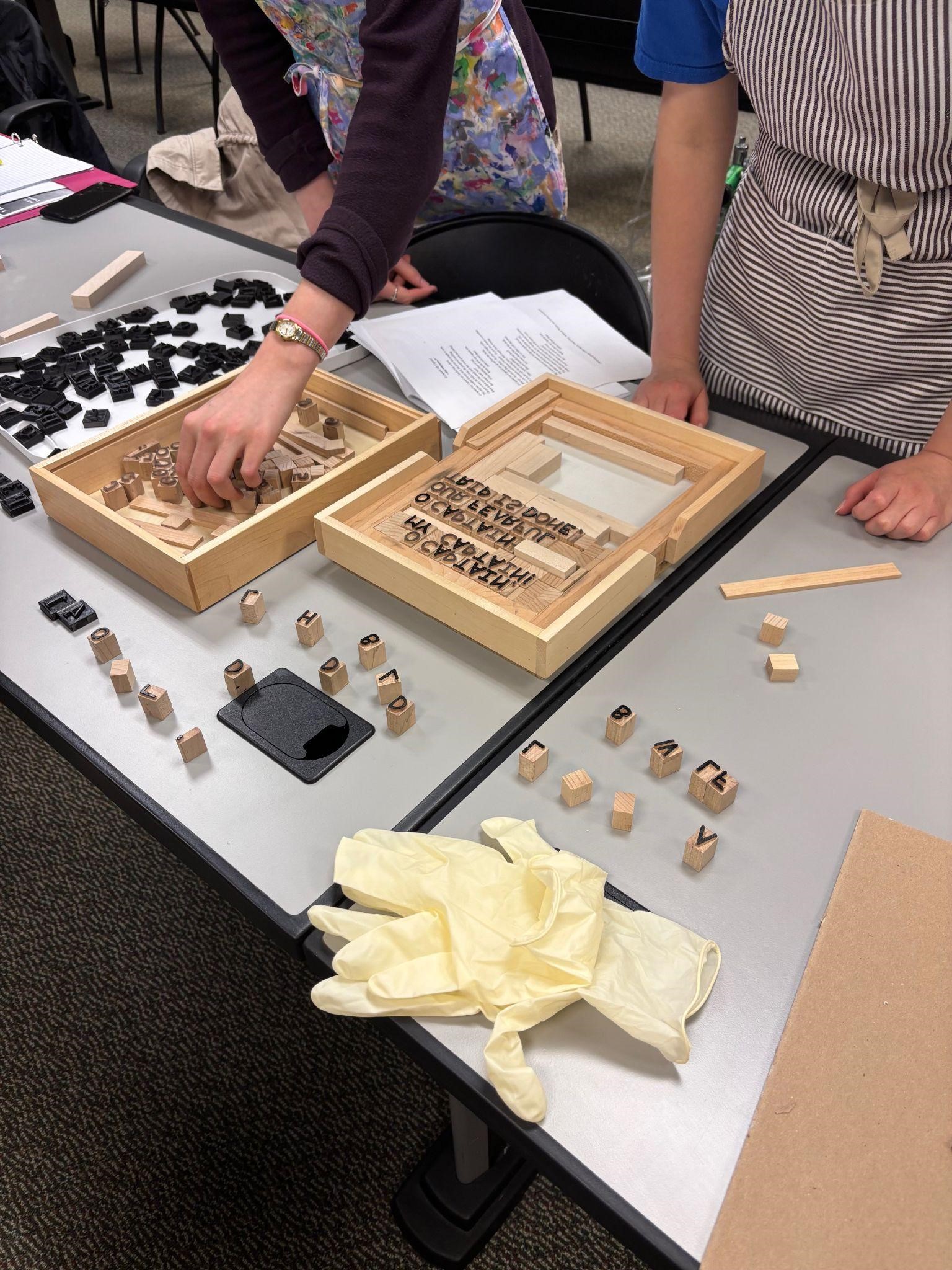 Sarah Ray and Lydia Spicer use movable type to lay out a page. Sarah Ray and Lydia Spicer use movable type to lay out a page.
