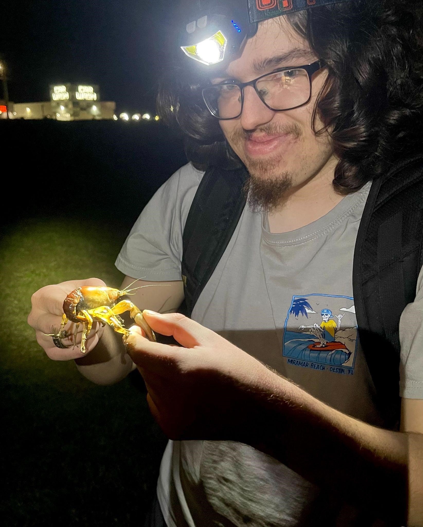 student with crayfish