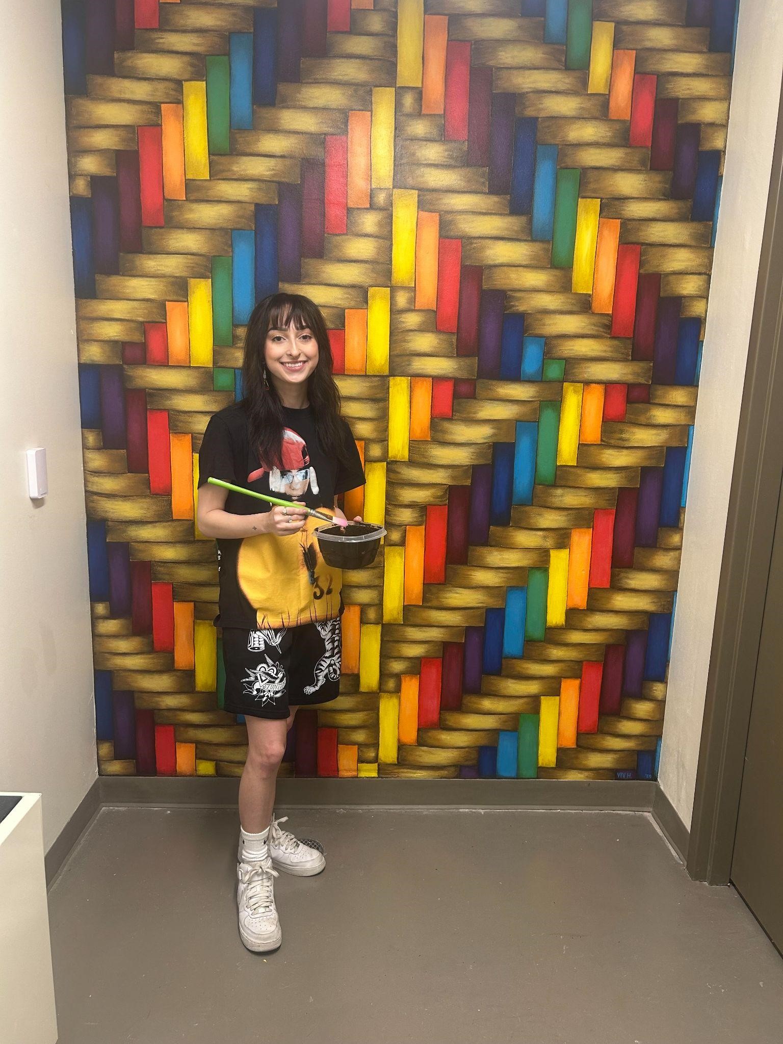Vivian Howerton in front of her wall mural