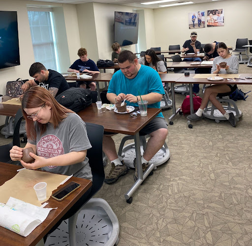 Students in class making pottery 