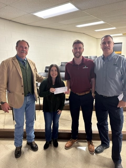 Executives from Amerisafe Insurance present a check to Sarah Eaker (NSU EHSM ’24), president of the student chaper of the American Society of Safety Professionals. 