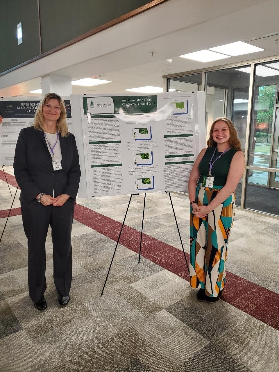 Kent and Dr. Doyle with their poster presentation at the conference.