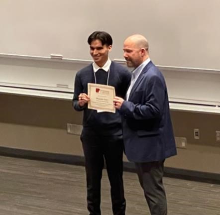 Alejandro Lopez being awarded Honorable Mention at the Arkansas-INBRE annual conference