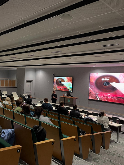 Students and residents watch the surgery live.