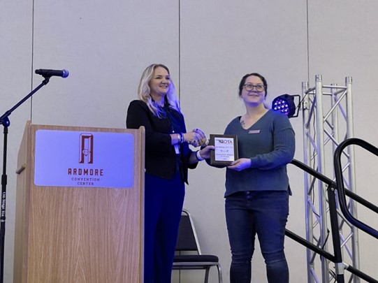 Tara Ottenbacher MOT/L receiving the Occupational Therapist of the Year Award at the 2023 Oklahoma Occupational Therapy Conference (OKOTA).