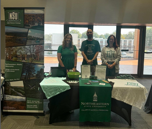 Dr. Kim Cuellar, Brian Vickers, and Sydney Rice next to informational table