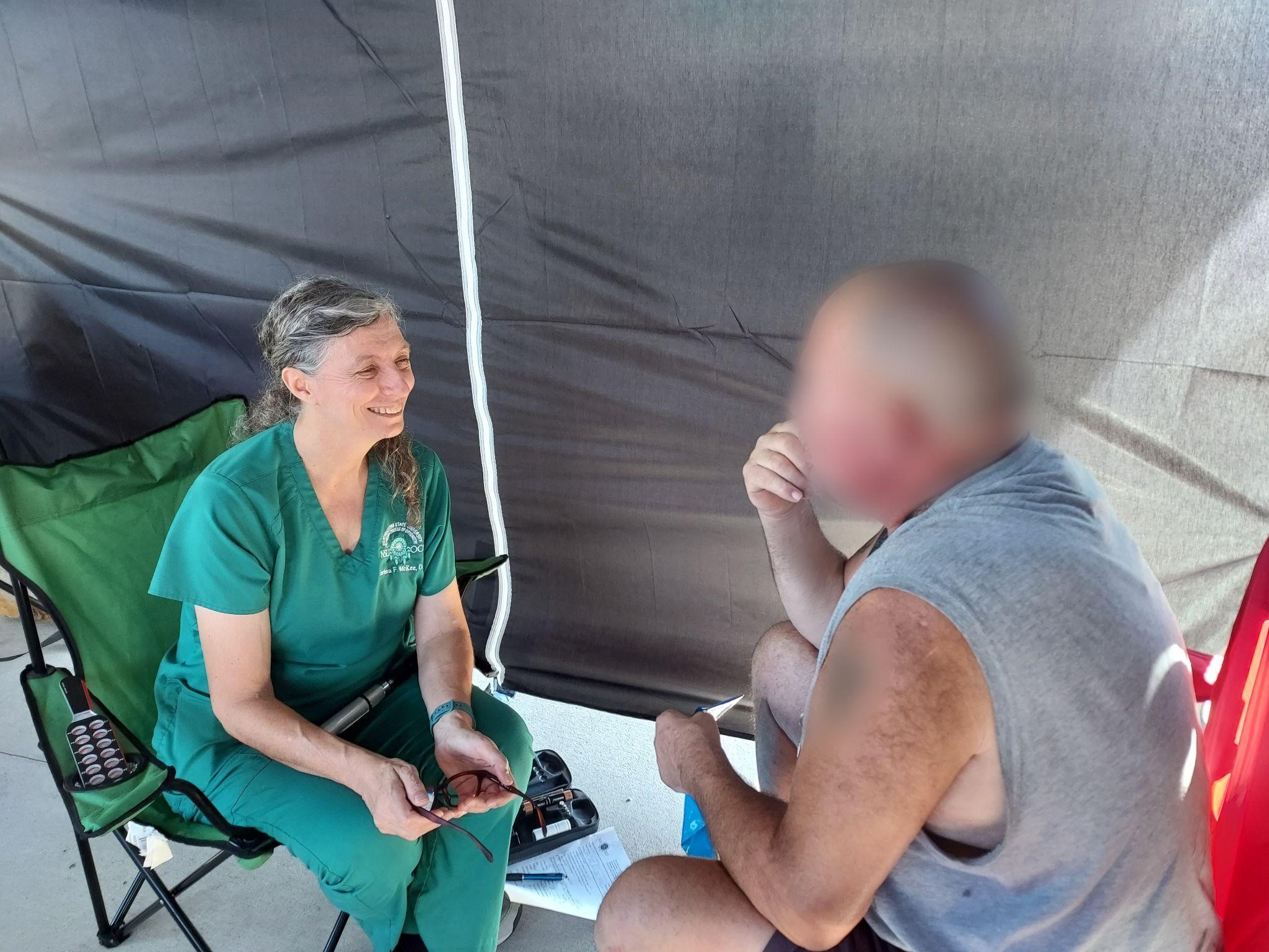 Dr. Earlena McKee doing a vision Screening on a patient.