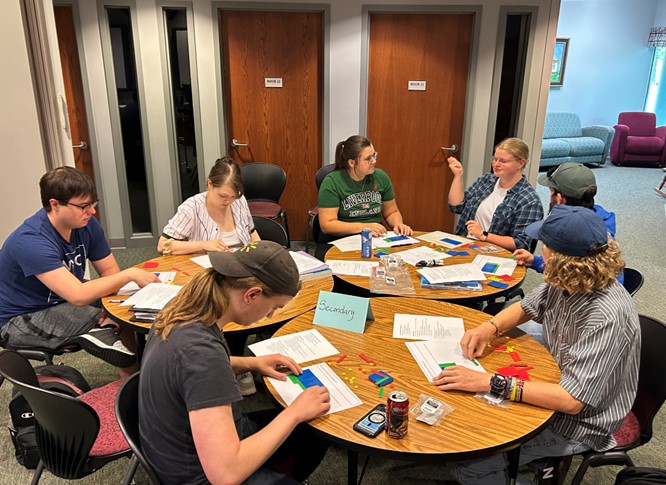 Math Clinic teachers learn how to use algebra tile manipulatives as they prepare for their teaching sessions with K-12 students from the community.  Students Pictured: Caleb Rowe, Jordan Mischke, Emily Dixon, Brooklin Landers, Avi Delap, Ethan Sisk and Kyle Newell.
