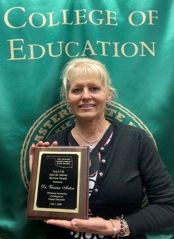 Dr. Vanessa Anton holding OACTE Jane M. Morse Service Award plaque.