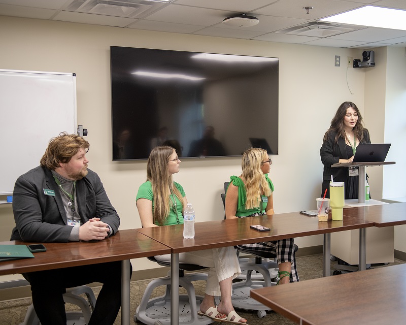 OSTCA - Angel Ford, graduate student, moderates an undergraduate to graduate panel discussion at the Oklahoma Speech Theater Communication Association annual conference. Photo by Cassie Freise