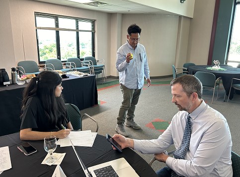 Noyce Scholars Eduardo Cresensio and Saabrina Albiter engage in high quality math and science tasks with Dr. Spence Pilcher.